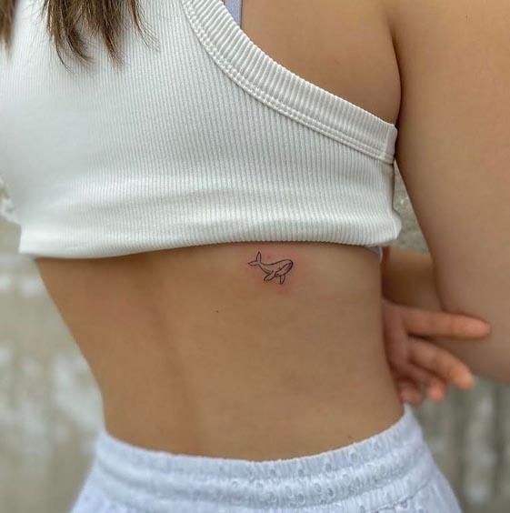 small cute whale tattoo design fineline female back rib