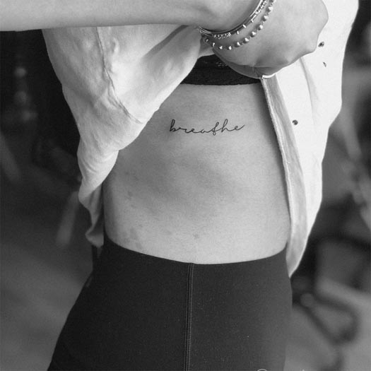 word breathe tattoo minimalist design female ribcage