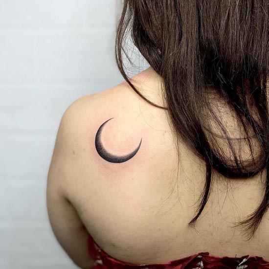 simple moon tattoo woman left back shoulder