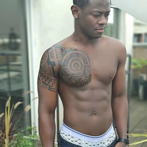 tribal chest to shoulder tattoo design male dark skin