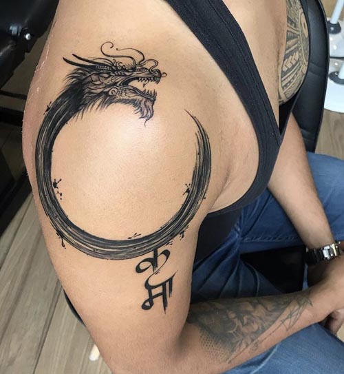 round dragon word karma in hindi tattoo design man shoulder