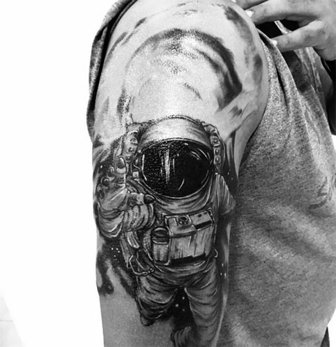 spaceman tattoo astronaut man shoulder bicep