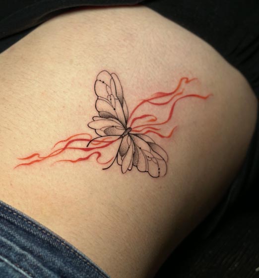 butterfly and fluid flow in background fine line tattoo female side ribs