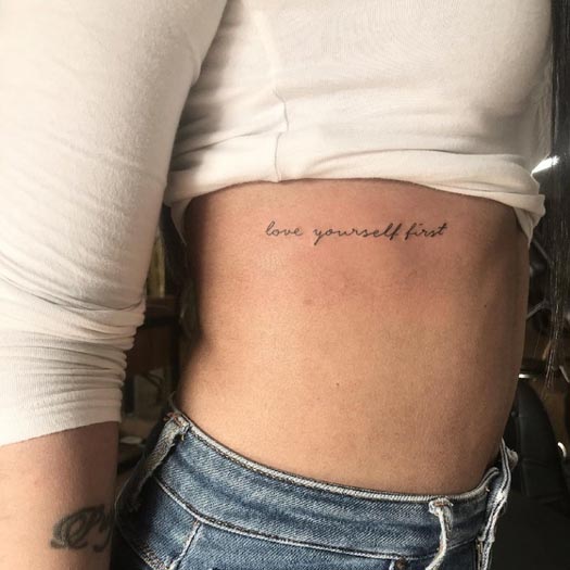 cursive writing quote love yourself first tattoo lady right side