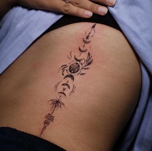 phases of moon lotus unalome tattoo female vertical side rib