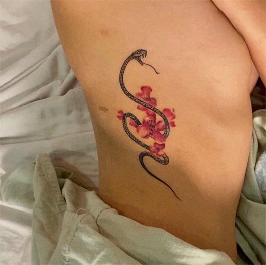 snake with flowers elegant tattoo design girl side