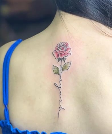 small rose tattoo design on female spine