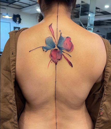 unique watercolor abstract colored flower tattoo design female spine