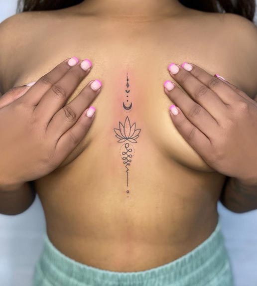 ornamental lotus linework tattoo sternum