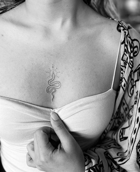 snake tattoo design minimalist linework female sternum