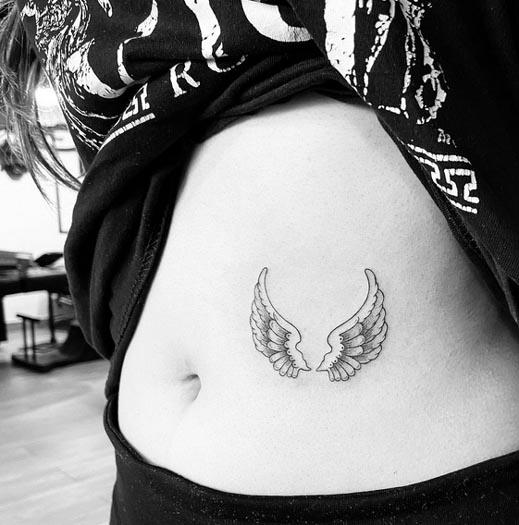 2 small angel wings tattoo design female stomach minimalist