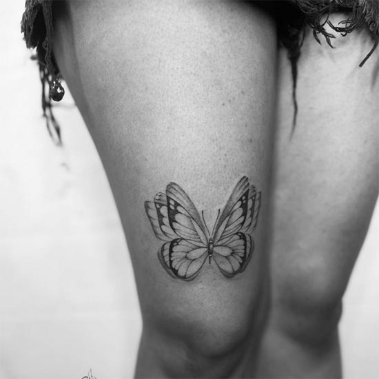 cute butterfly tattoo design black and grey female lower thigh