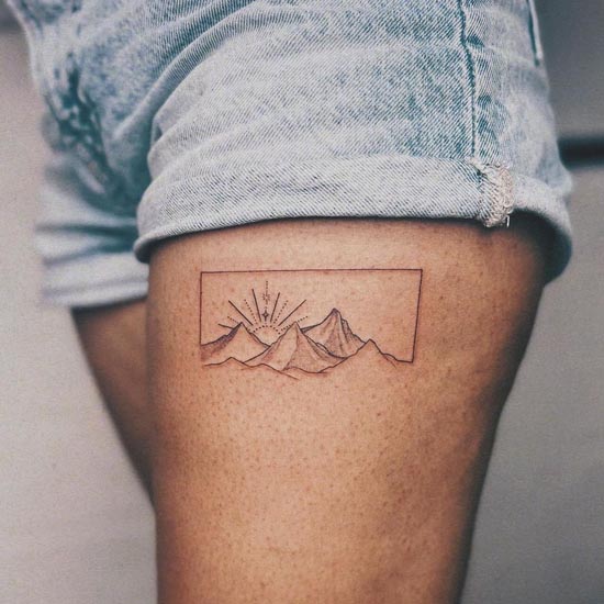 small mountain sun fine line tattoo female upper thigh