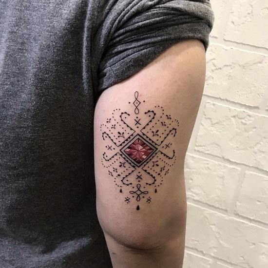 geometric ornamental tattoo red crystal design lady outer tricep