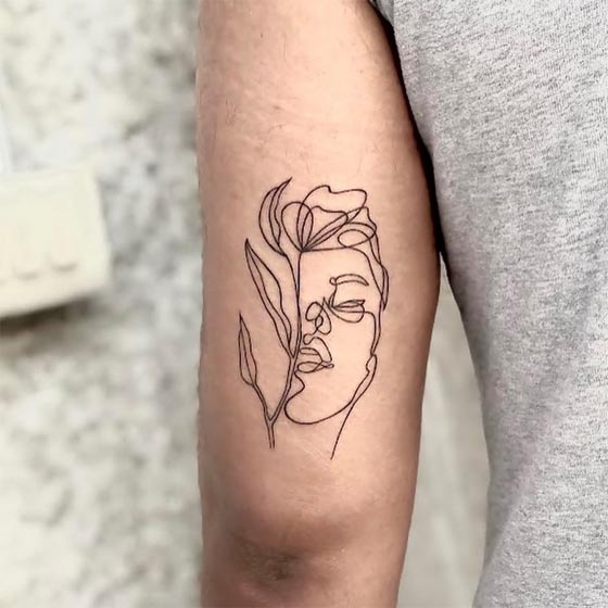 half face half flowers tattoo illustration linework male tricep