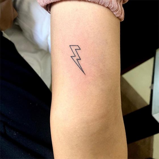 lightning small easy tattoo idea girl lower tricep