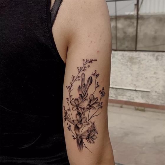 rajnigandha tuberose flower tattoo black and grey lady outer tricep