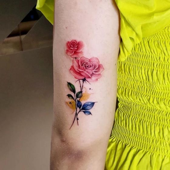 rose tattoo semi realistic abstract female outer tricep