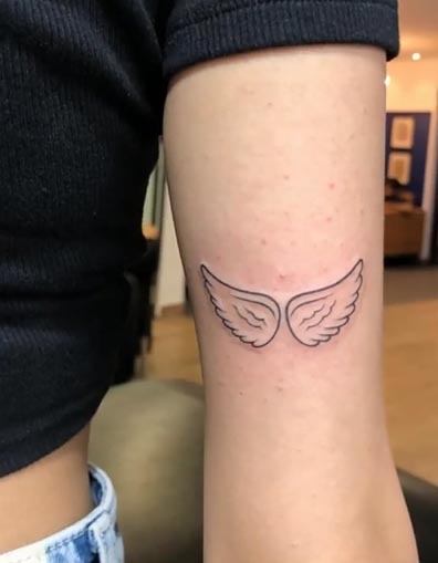 small 2 angel wings tattoo design on girl tricep