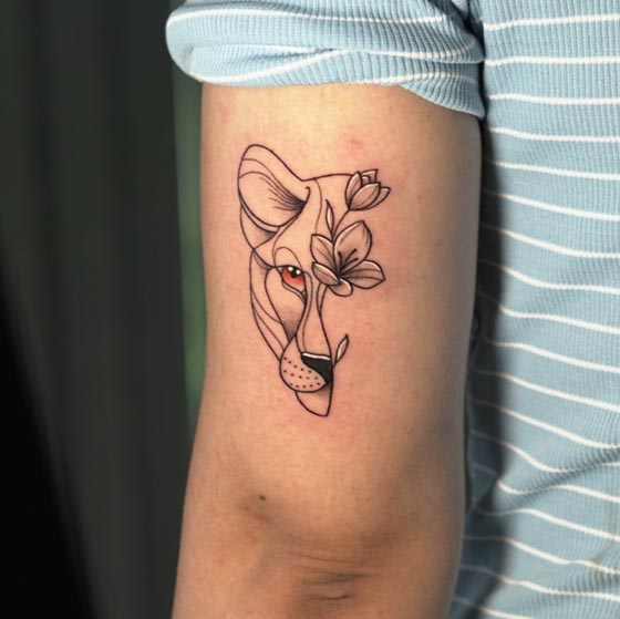 small half tiger face half flowers woman tricep