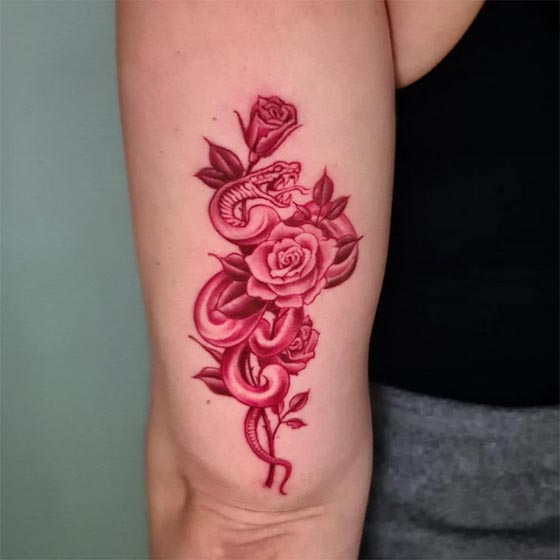 snake wrapped around rose tattoo design color red female outer tricep