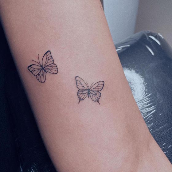 tiny 2 butterfly cute tattoo design linework woman outer tricep