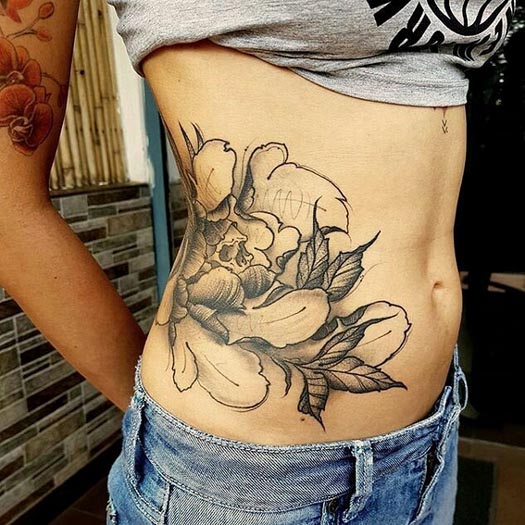 skull with flowers nice tattoo female side waist