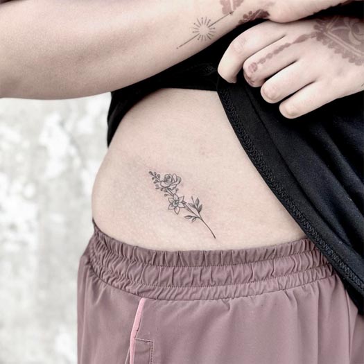 small flower simple tattoo design woman side waist fine line