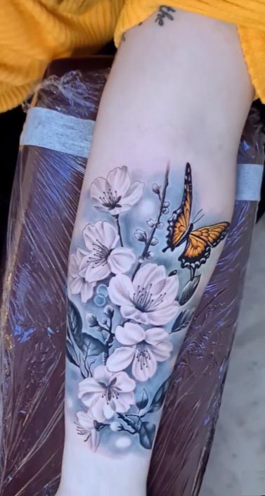 arm cherryblossom and butterfly tattoo