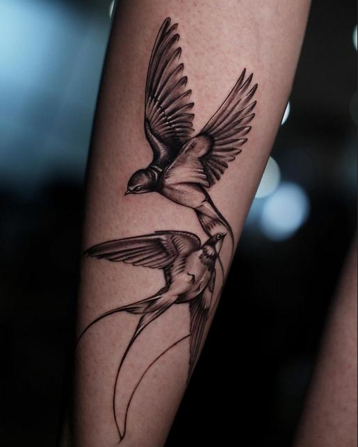 forearm birds soar high tattoo