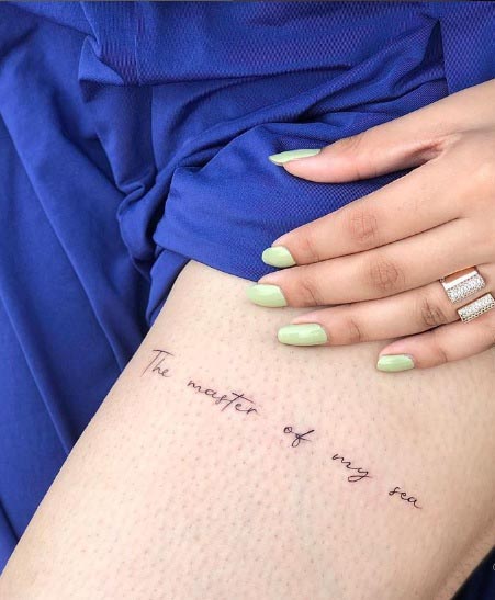 thigh simple text tattoo