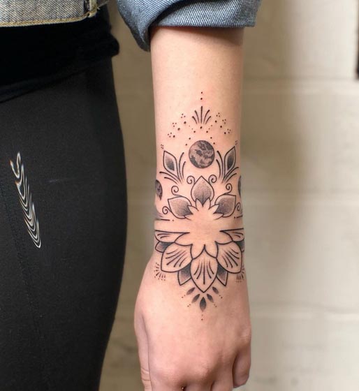 big ornamental mandala tattoo design female hand wrist forearm