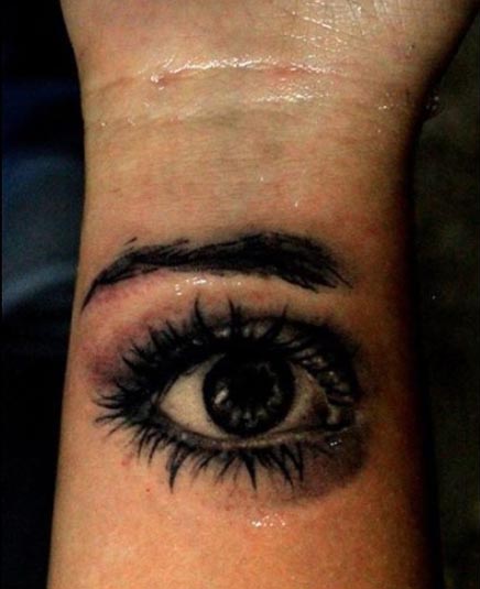 big realistic eye tattoo black and grey woman wrist