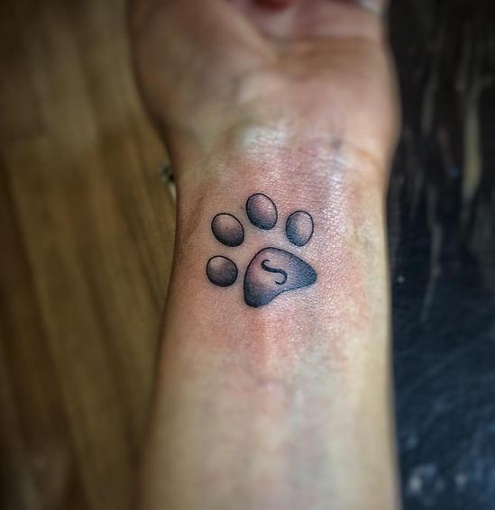 cute dog paw tattoo design female wrist