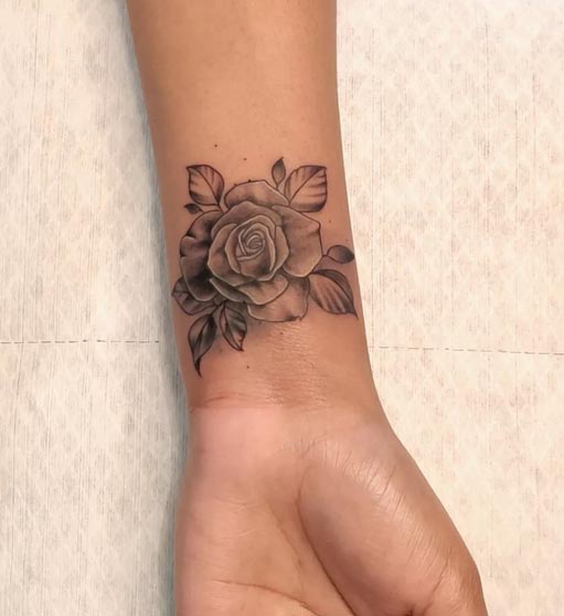 delicate rose tattoo design female inner wrist