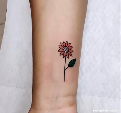 small pretty sunflower with leaf tattoo female wrist