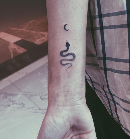 small snake crescent moon tattoo dotwork female wrist